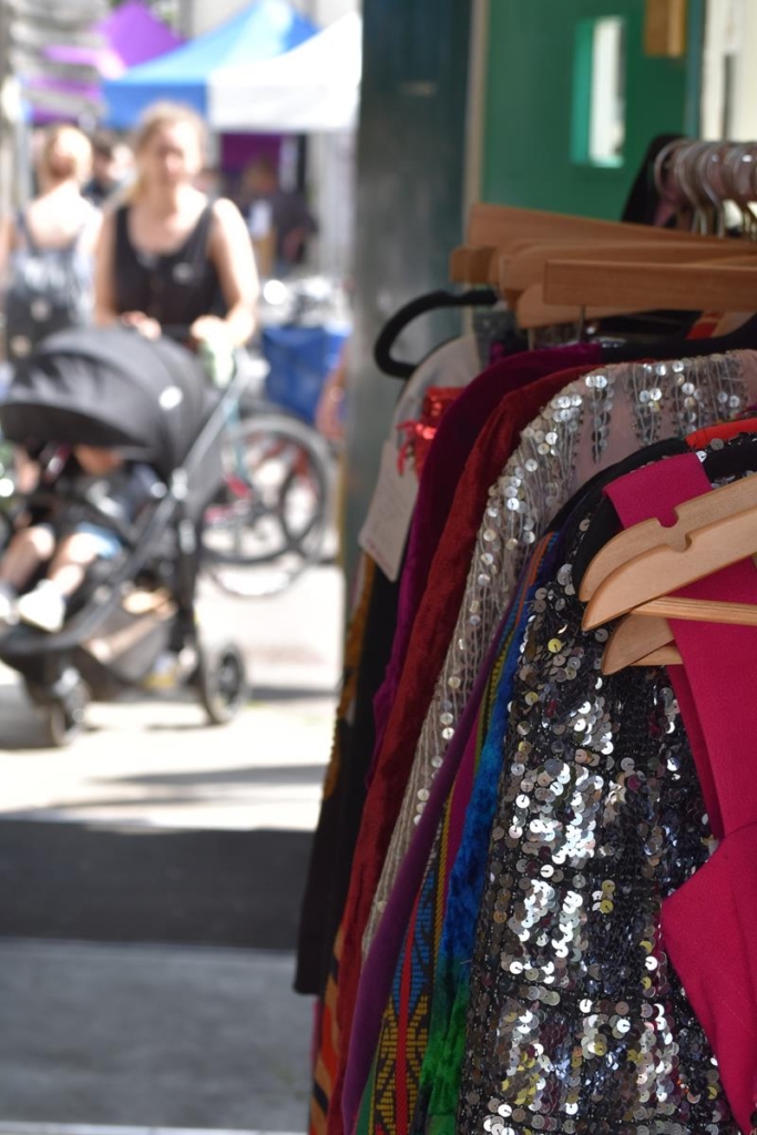 Detail of a market clothes rail, with sparkly tops.