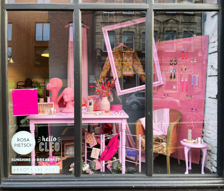 Shop window display in Old Market, Bristol with bright pink theme and designer hand-made accessories