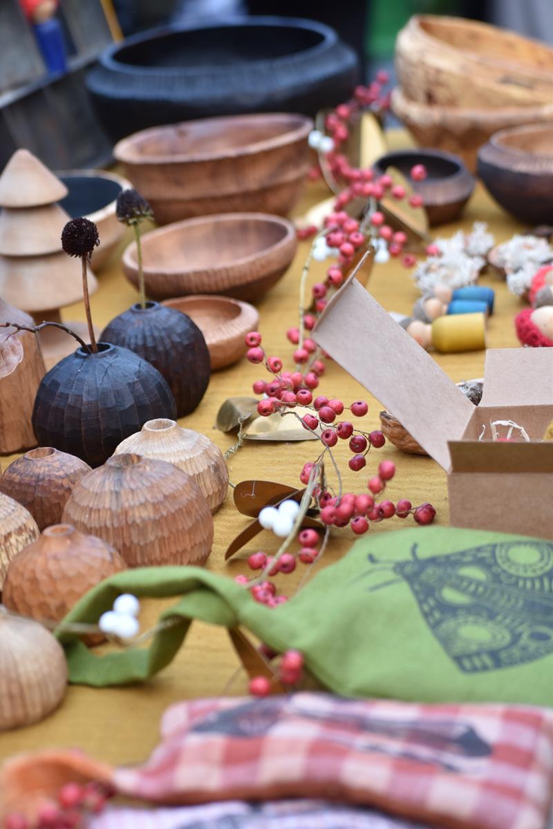 Hand-carved wooden artworks, at a Christmas-themed market stall.